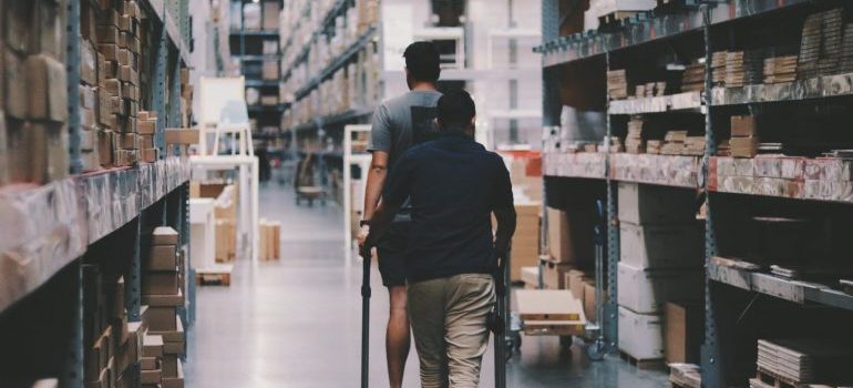 men in a warehouse - choosing a storage space online