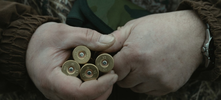 A man holds bullets