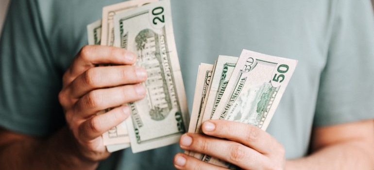 A person holding dollar notes 