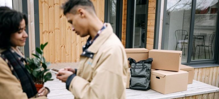 couple with moving boxes on the porch