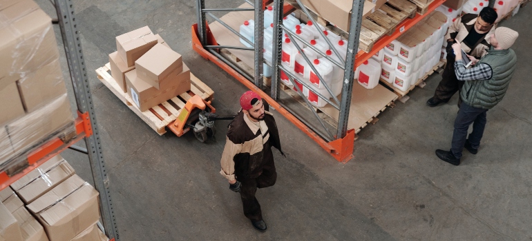 A worker pulls a cart with things