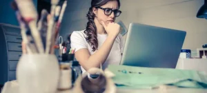A girl looking at a laptop