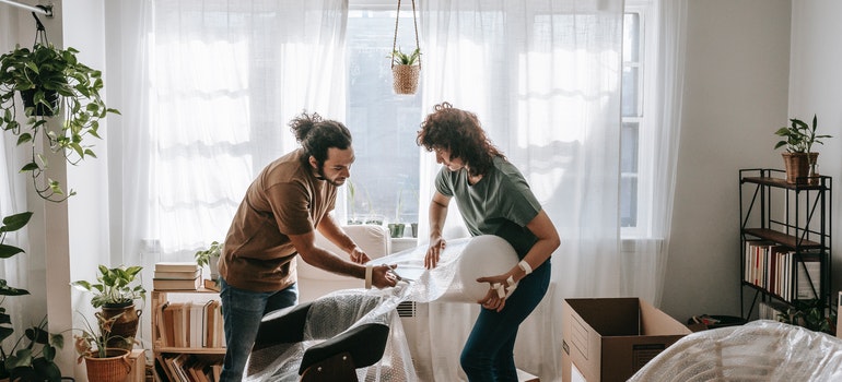 Couple wrapping a chair