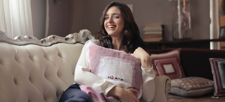 a woman sitting on a couch and smiling