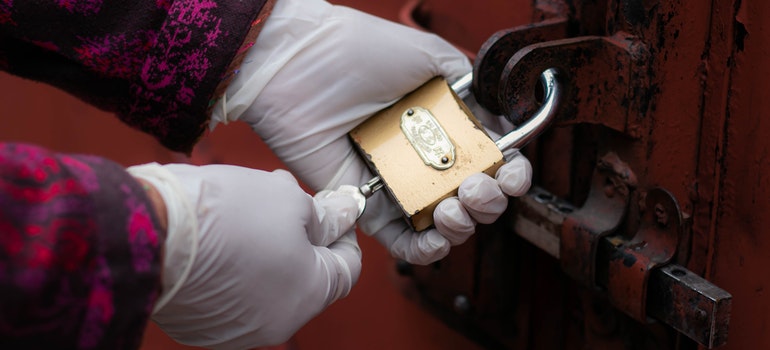 A person locking their storage after reading the benefits of self storage for home staging professionals