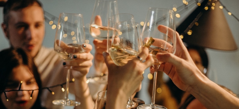 people holding glasses and cheering