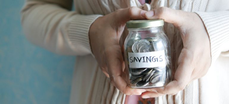 Woman holding a jar of pennies