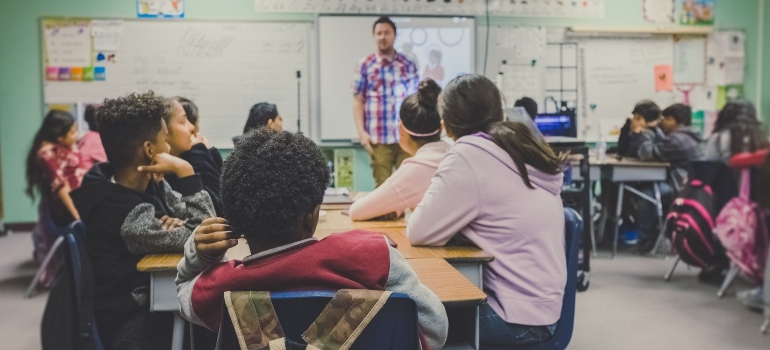 A man teaching a class after moving from Newcastle to Portland