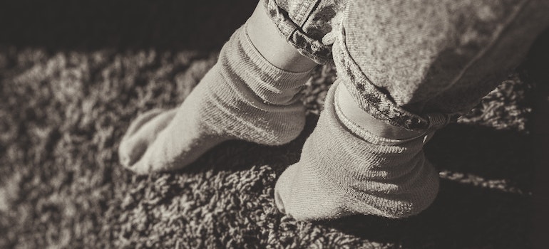 Person touching carpet with their feet