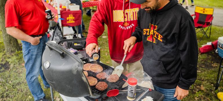 men cooking food on a grill