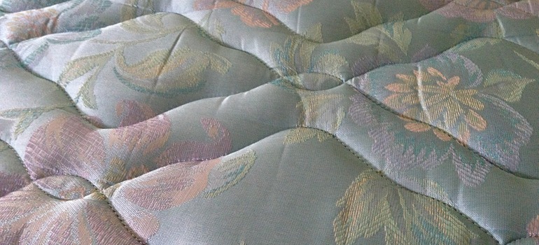A bed mattress before storing a king size bed