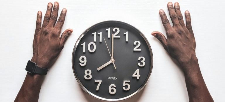 man looking at a clock