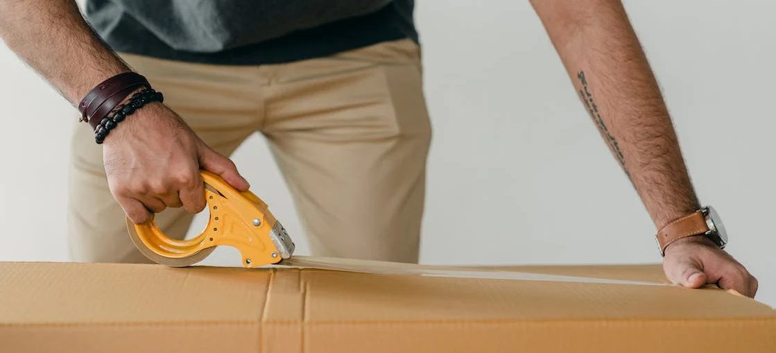 A man preparing his belongings for storage