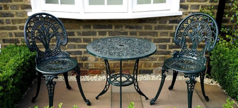 a black table and two chairs made of steel