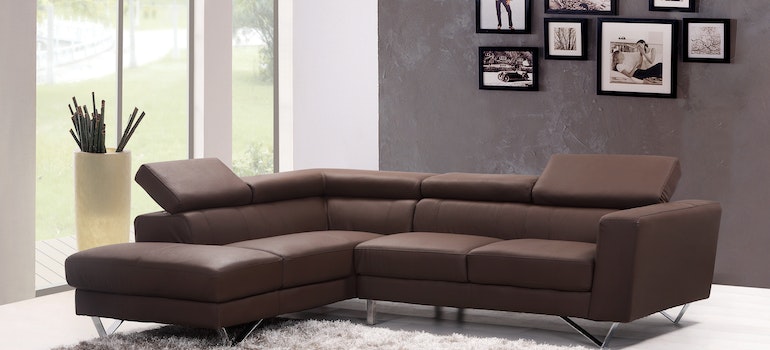 A clean brown leather sectional sofa as example of how to prepare furniture for storage