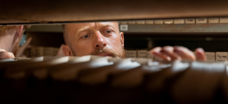man checking stored documentation