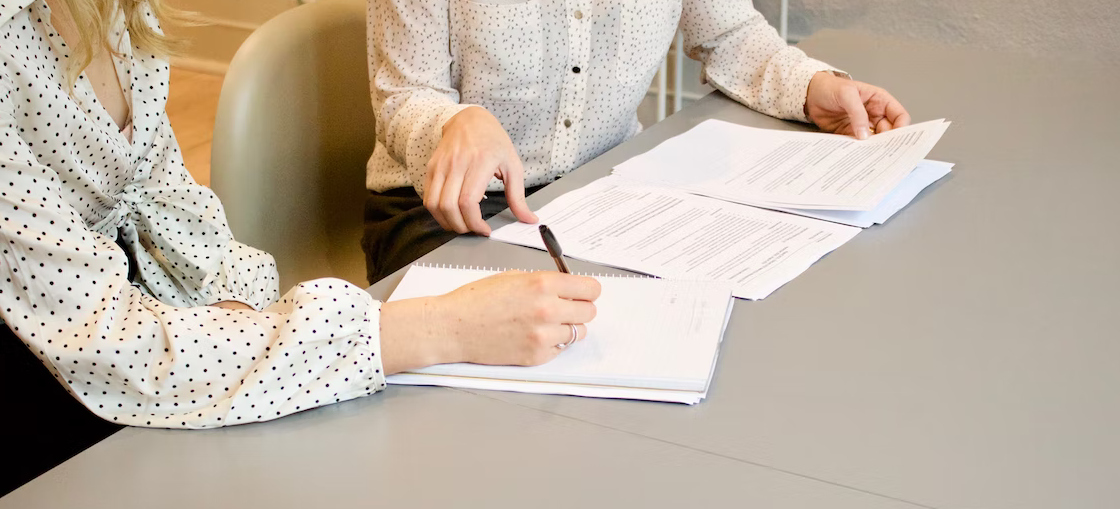 Two women looking at papers and going through shipping tips for Washington businesses
