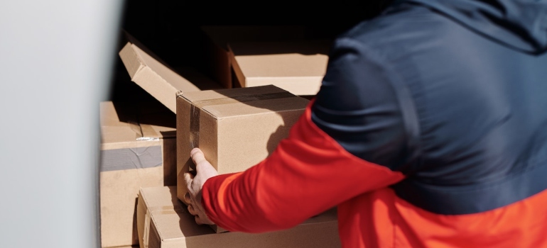 A man loading boxes after renting portable storage containers