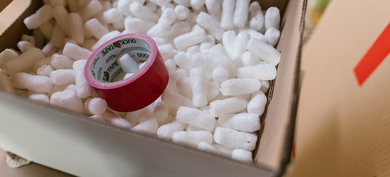 red scotch tape inside a box with polystyrene
