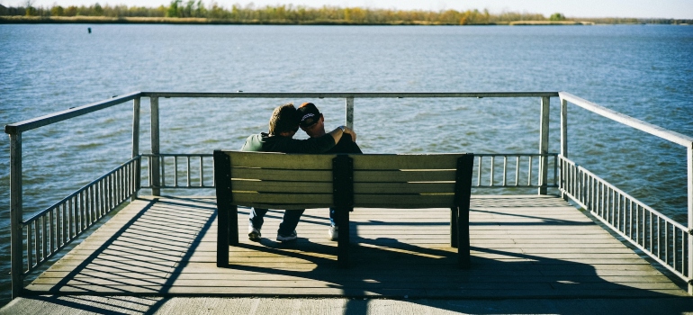 people sit on the bench and watch the lake after renting Lynnwood self storage