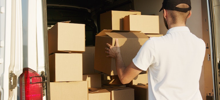 A man is packing belongings for moving to a condominium in Seattle.
