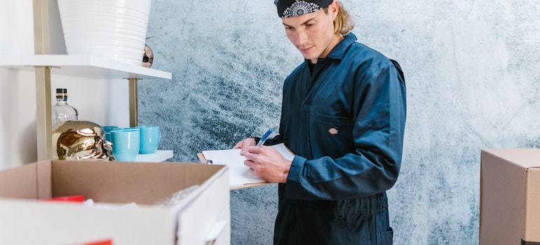 Mover checking a box and packing for Woodinville self storage