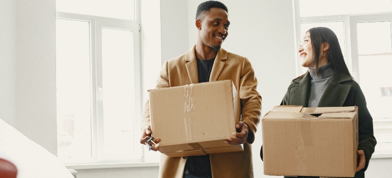 people holding moving boxes