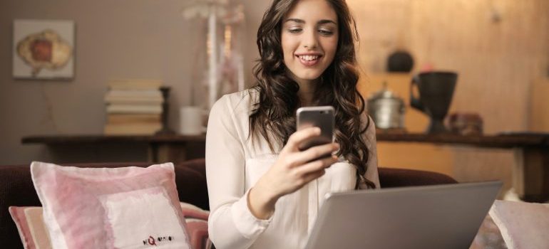 Girl smiling while looking at her phone