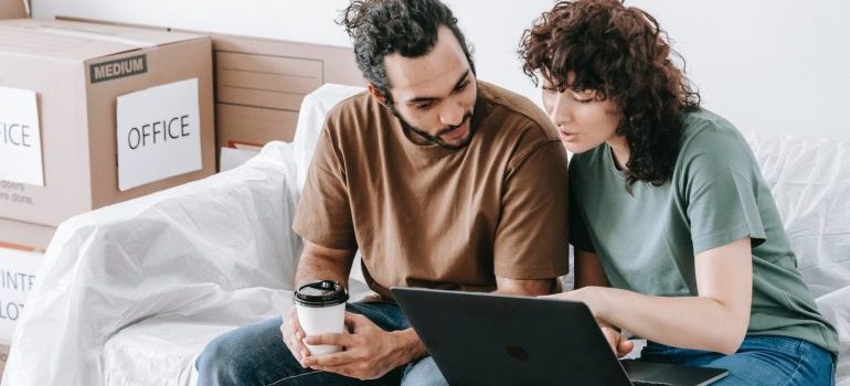 Couple using their laptop to research how portable storage can help you reclaim your Lynnwood home