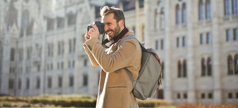 A smiling man taking photos thanks by mobile storage for Lynnwood jet setters