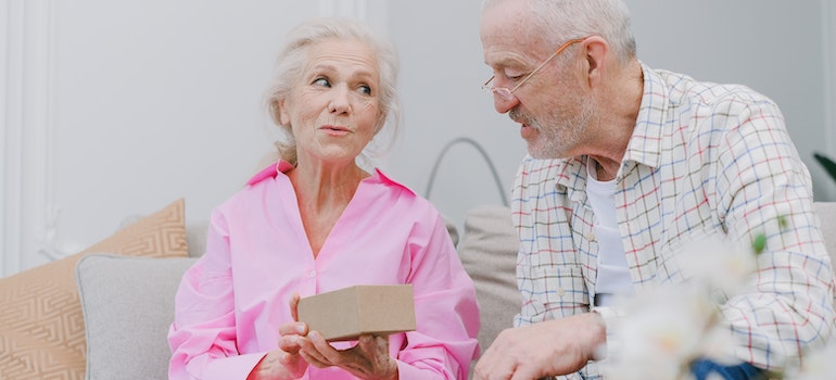 An elderly couple sharing a present