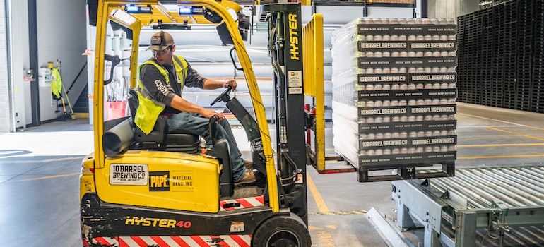 A Person Using Forklift in storage 