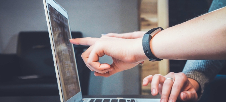 Picture of a person pointing at a screen 