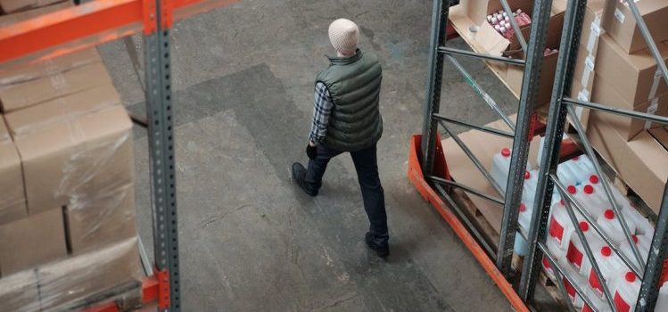 A man walking down the aisle and thinking about storage tips for theater groups in Seattle