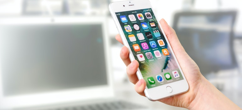 A person holding a phone to prevent Damage in a Storage Unit by using apps