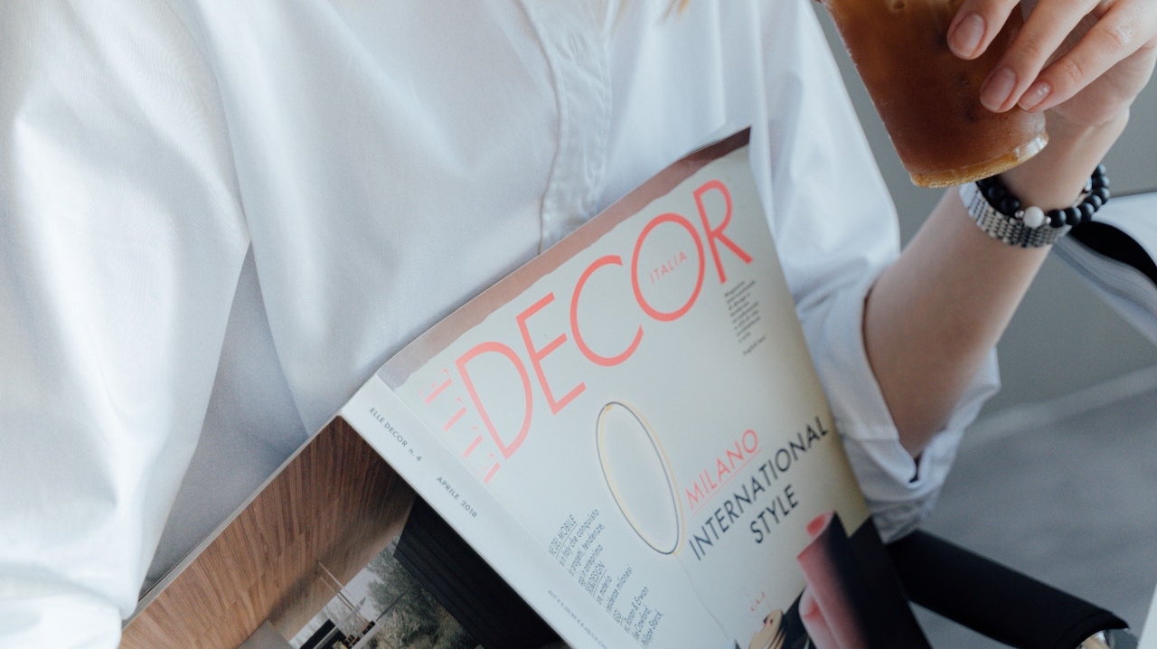 Woman in White Dress Shirt Holding a Magazine describing How strategic storage enhances the design process