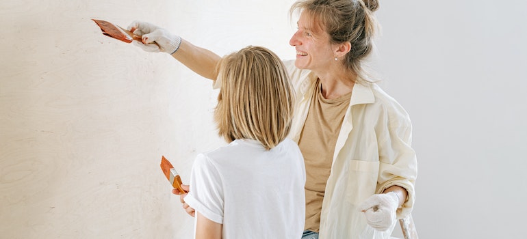 Mother and daughter are Painting the Wall before merging two households