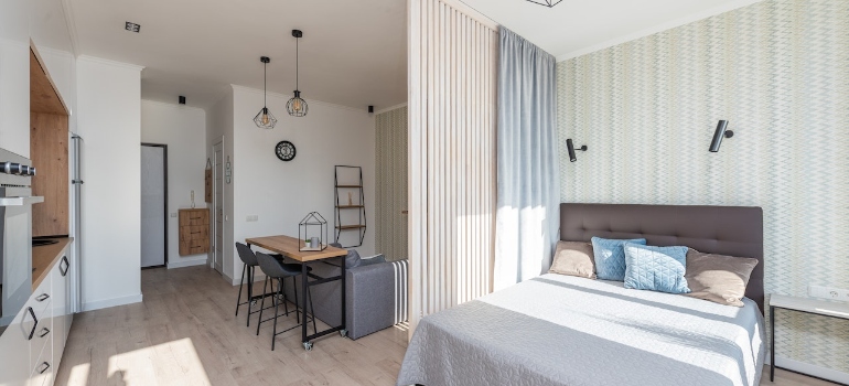 Modern flat with cozy bed and loft style lamp