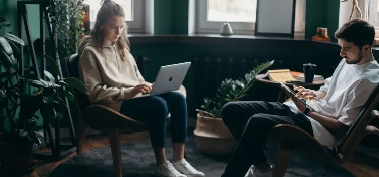 A couple working on their laptops and researching about perks of portable storage for work-at-home parents