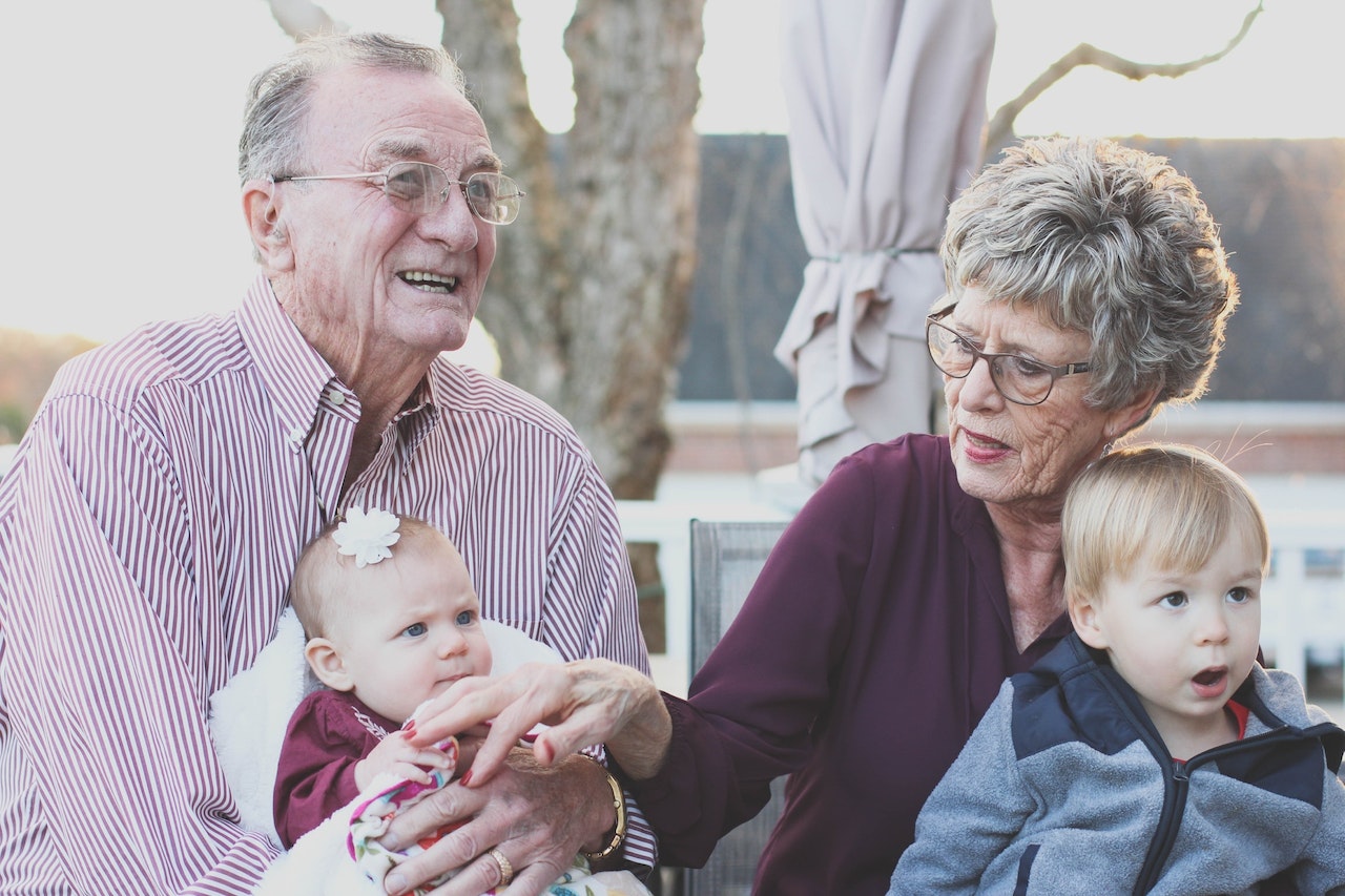Grandmother and Grandfather each Holding a Child on Their Lap