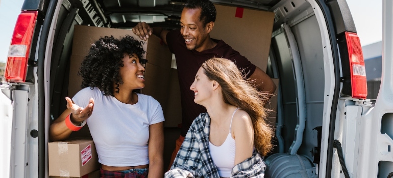 Man and Women Sitting on White Van during one of temporary relocations in WA