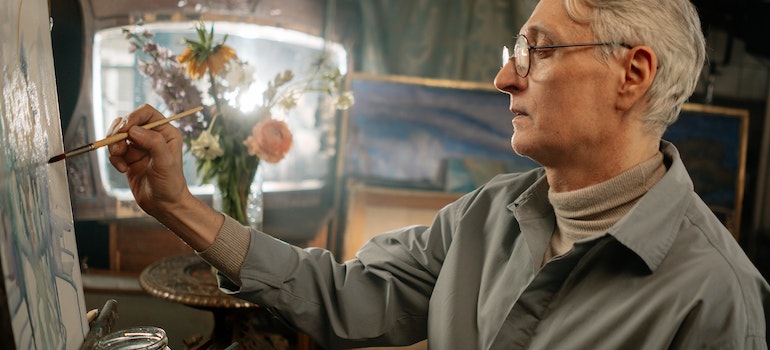 Elderly man painting