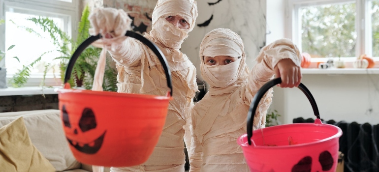 Two kids in mummy costumes