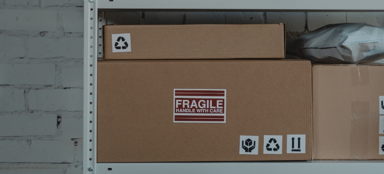Brown Cardboard Boxes on a Steel Shelf