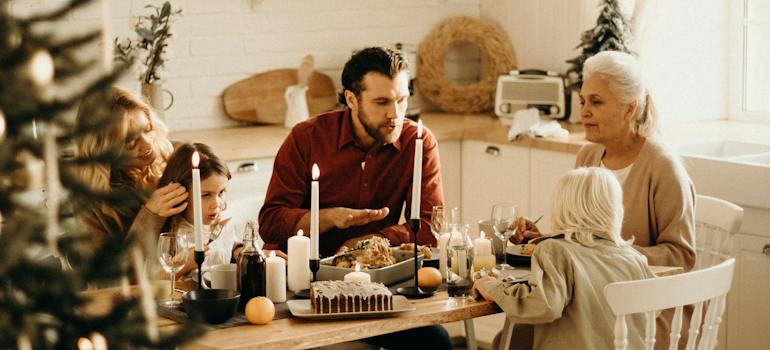 Family sitting near dining table and eating