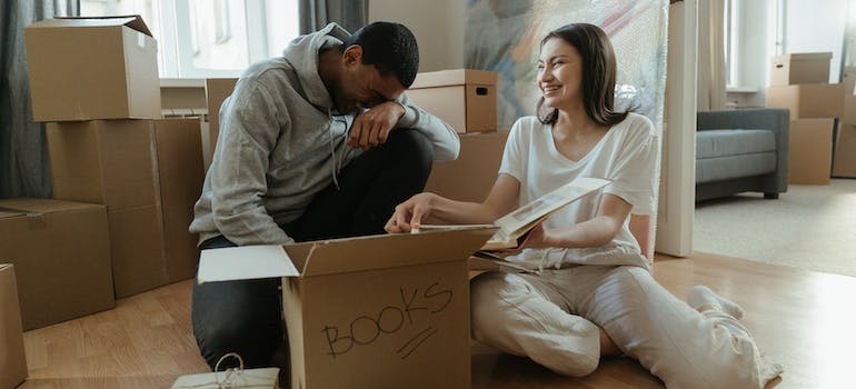 A man sitting beside a woman and looking at photos and smiling