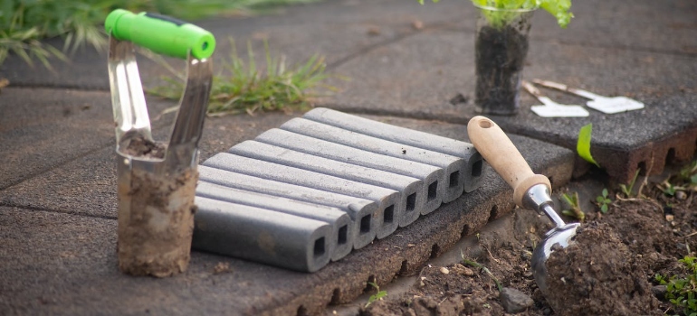 a set of gardening tools in the dirt
