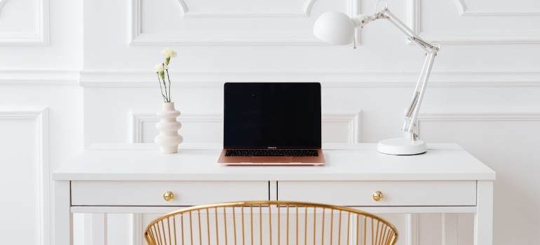 Laptop on a wooden white desk presenting minimalist lifestyle in Marysville