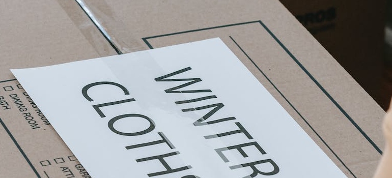 A labeled Box Of Winter Clothes
