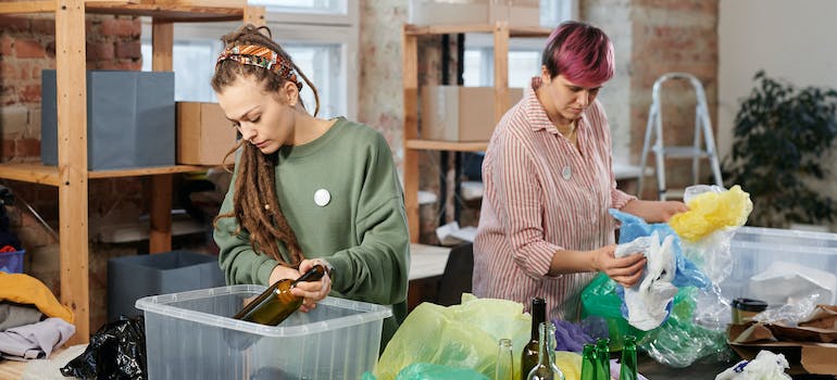 Two women sorting plastic waste